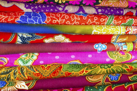 Colorful pile of batik fabrics or textilesの写真素材