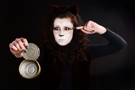 Portrait of cat-girl with an empty can. Studio shot.の写真素材