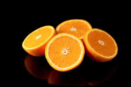 Sliced oranges on black background  Studio shotの写真素材