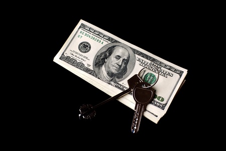 U S Dollars with two keys on black background  Studio shot の写真素材