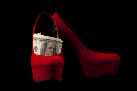 Pair of red female shoes and dollars on black background  Studio shot の写真素材