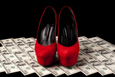 Pair of red female shoes and dollars on black background  Studio shot の写真素材