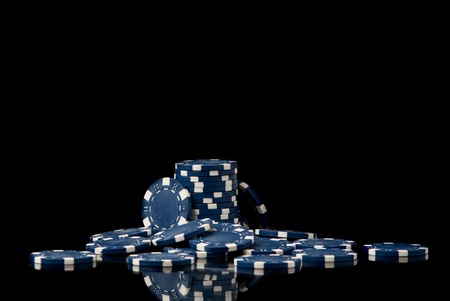 set of blue poker chips on black background. Studio shotの写真素材