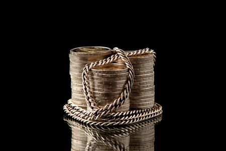 EURO coins chained with silver chain on black background. Studio shot.の写真素材