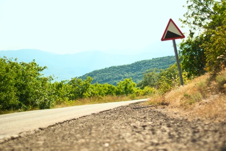 Picture of the mountain road and a road signの写真素材