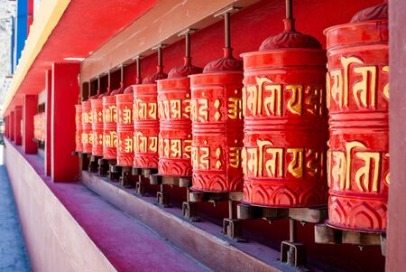 Picture of buddhist prayer wheels in a rowの写真素材
