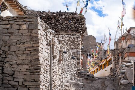 The ancient tibetan village Kagbeni in the Himalayas, Annapurna conservation area, Mustang Kingdom. Old stone residential houses with firewood on the roofs.の写真素材