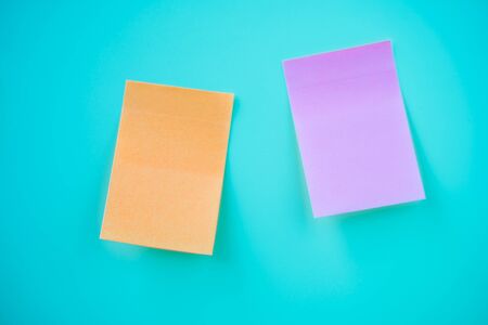 Orange and purple Sticker notes on blue background. Stock photoの写真素材