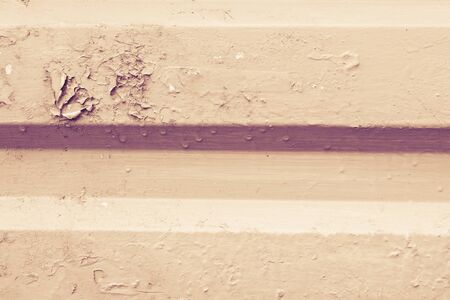 Texture of pilled front oil paint on metal roofing. Color tinted in red sepia. Abstract Background....