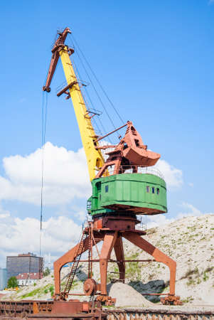 Old rusty port cranes in the industrial zone. Stock photo