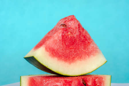 Water melon slices on blue background. Juicy fresh tasty summer dessert. Stock photoの写真素材