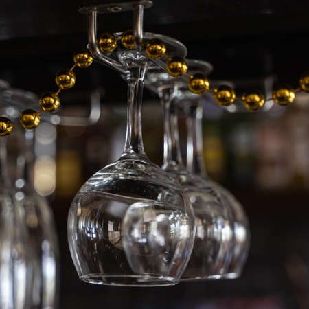 Wine glasses hanging over the bar. Soft focusの写真素材