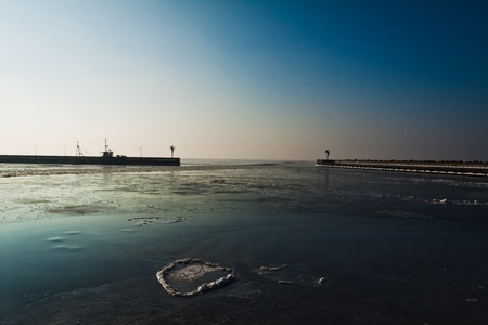 Winter sunrise in frosen harborの写真素材