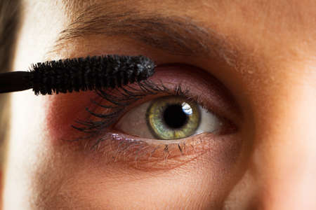 Woman painting  eyelashes 