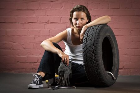 Beautiful mechanic in auto repair shopの写真素材