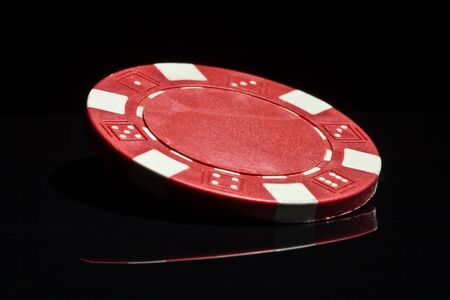 Red chip on black reflection tableの写真素材