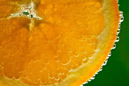 Orange fruit in sparkling waterの写真素材