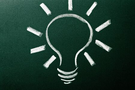 Light bulb as idea concept on green blackboardの写真素材