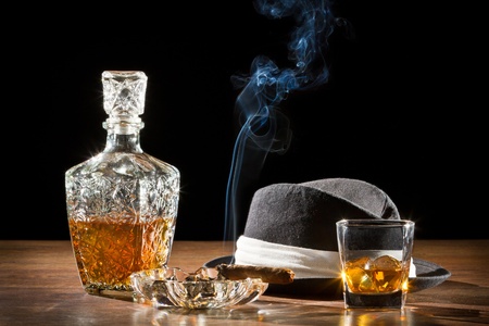 Retro hat, smoking cigar and whisky on rockの写真素材
