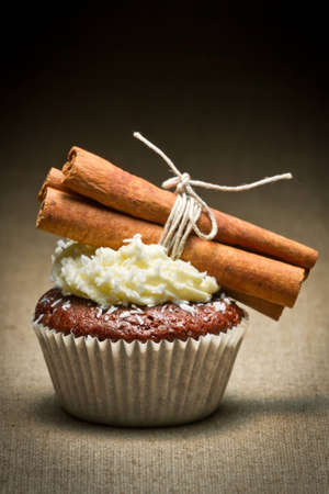 Chocolate muffin  with cinnamon bark and creamの写真素材
