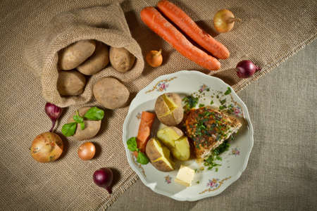 Vegetables, jacket potatoes, and roast chicken in rural meal