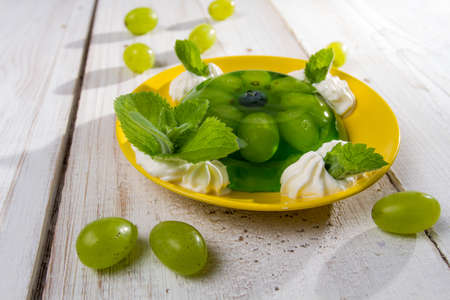 Fruit jelly served with grapes