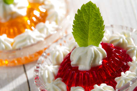 Red jelly with cream and mint leaf