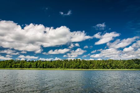 Blue sky with clouds at the lakeの写真素材