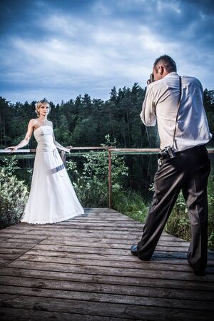 Groom takes a picture of the bride