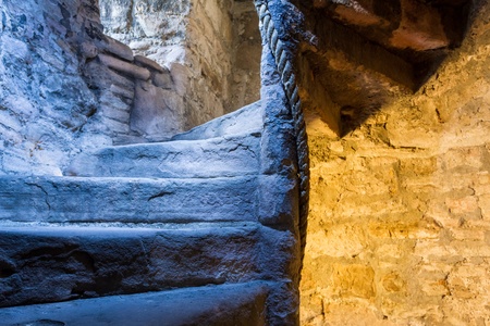Lighted stone staircase in a medieval castle