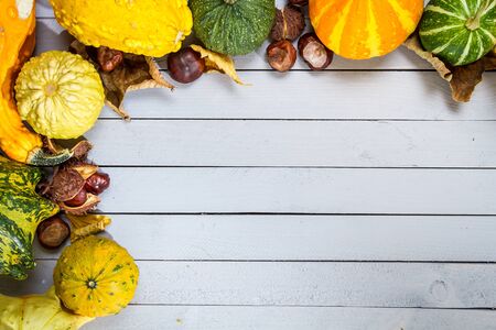 Pumpkins with autumn decoration on old wooden floorの写真素材