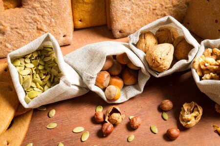 Close-up on different kinds of nuts on the background baked gingerbread