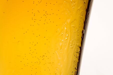 Closeup of glass of light beer on white background isolatedの写真素材
