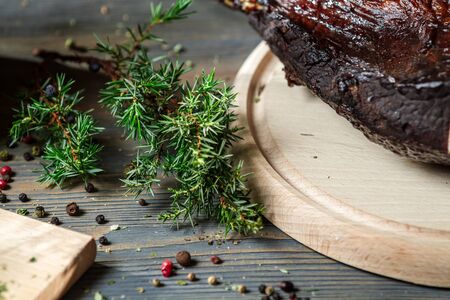 Closeup of juniper and fresh sliced ââsmoked hamの写真素材