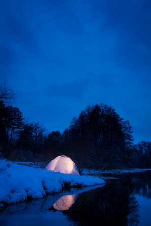 Warm accommodation in a cold snowy nightの写真素材