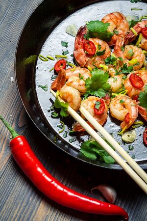 Shrimps sauteed with chilli pepper on panの写真素材