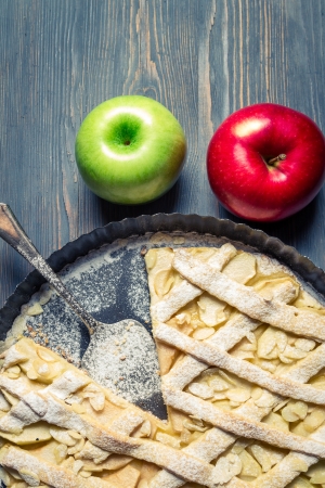 Apples and freshly baked apple pie on old blue tableの写真素材
