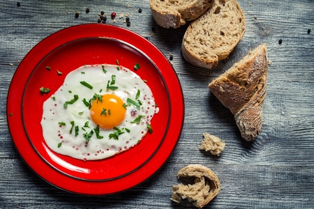 Closeup of egg served with parsley and bread