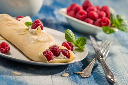 Closeup of raspberry pancakes with mint leafの写真素材