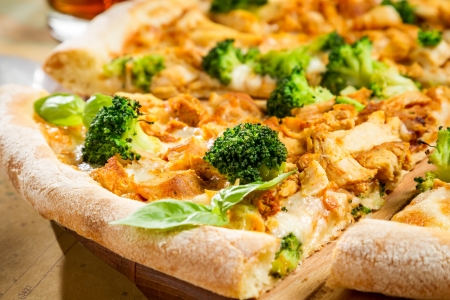 Closeup of fresh pizza with broccoli, chicken and cheeseの写真素材