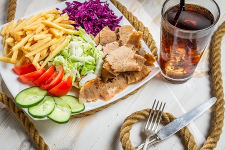 Closeup of vegetables, fries and meat kebabの写真素材