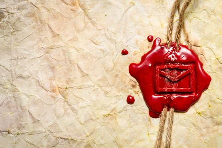 Closeup of envelope symbol imprinted in red sealing waxの写真素材