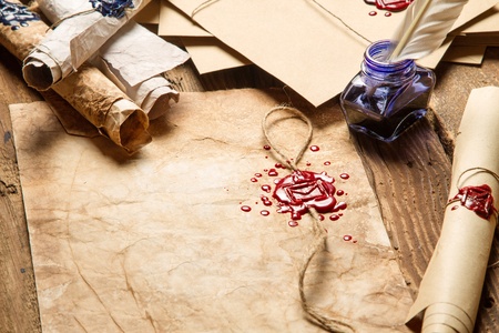 Closeup of old rolls of paper, glasses and blue ink in the inkwellの写真素材