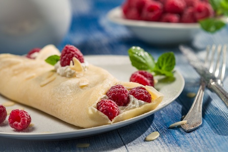 Closeup of raspberry pancakes with mint leafの写真素材