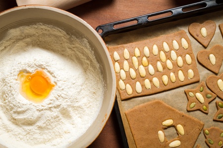 Decorating gingerbread cookies on the baking tray