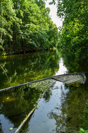 Old sunken boat on the river bankの写真素材