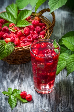 Juice from freshly harvested raspberries with iceの写真素材