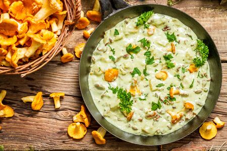 Fresh mushrooms cooked in a pan with creamの写真素材