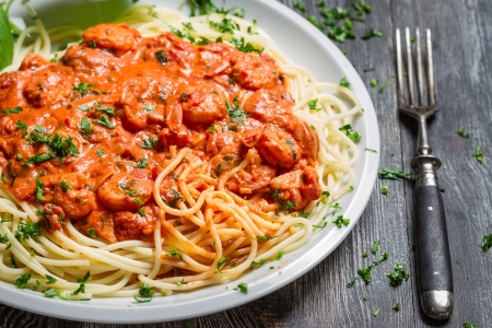 Spaghetti bolognese with shrimp and basilの写真素材