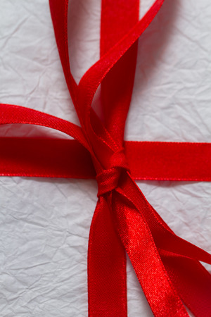 Red ribbon on a Christmas giftの写真素材